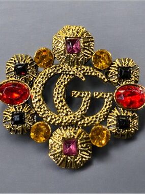GG Gold Tone Brooch with Red, Yellow, Black, and Pink Stones